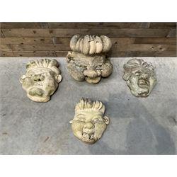 Four grotesque garden wall masks