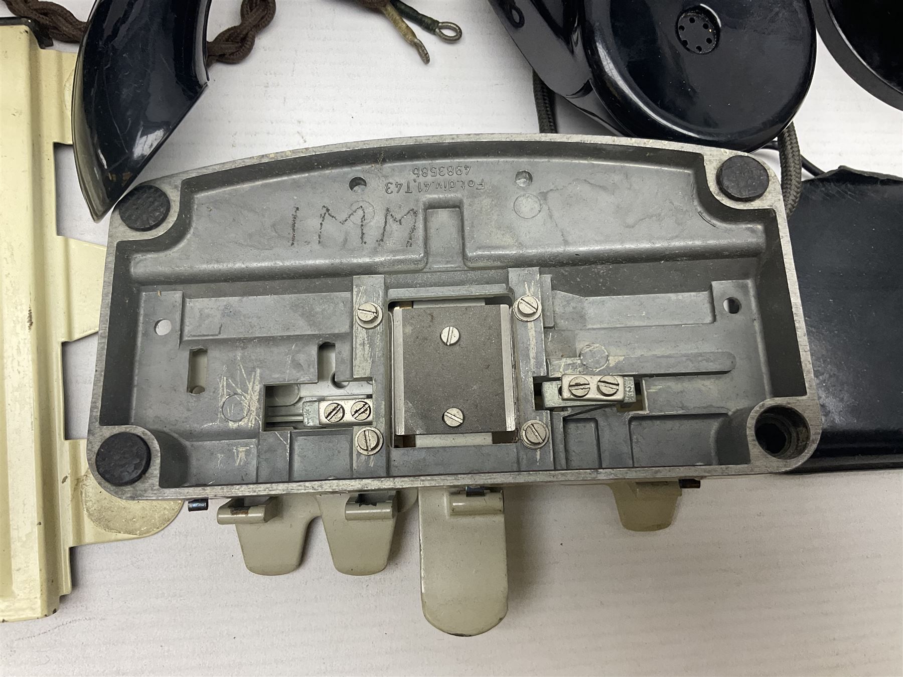 Collection of phone headsets, including GPO bakelite examples, together with other telephone parts 