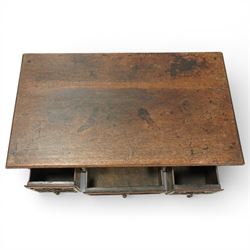 Early 20th century carved oak lowboy, rectangular moulded top above three short drawers carved with flowerhead panels and fitted with brass drop handles, shaped apron with foliate carving, raised on cabriole supports terminating in pad feet