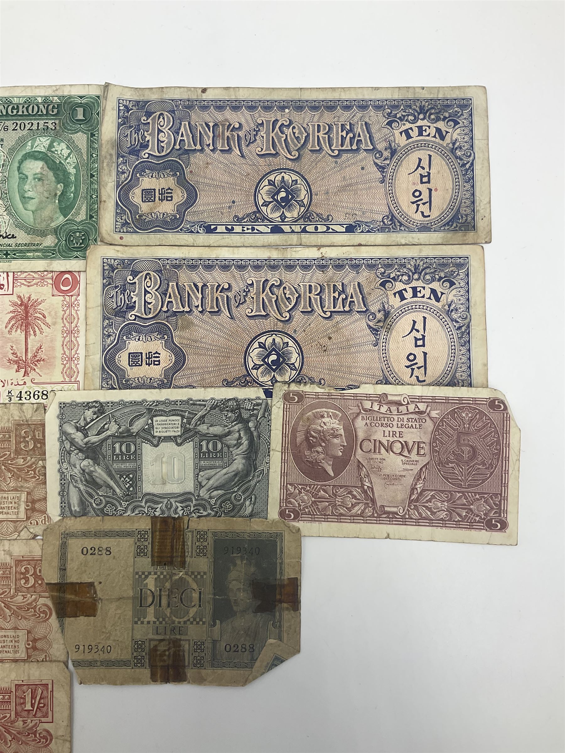 Banknotes including King George VI board of commissioners of currency Malaya one dollar 1st July 1941 'P/59 030908', Queen Elizabeth II Government of Hongkong one dollar 1st July 1952 'F/6 202153' etc
