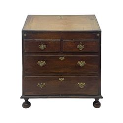 George III oak bureau, sloped fall-front enclosing a fitted interior with pigeonholes, small drawers, and a central compartment, over two short and two long drawers, brass escutcheons and drop handles, raised on bun feet