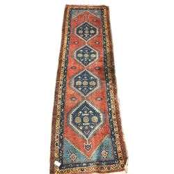 Turkish runner rug, red ground with quadruple pole medallion, three band border decorated with flower heads, 318cm x 91cm