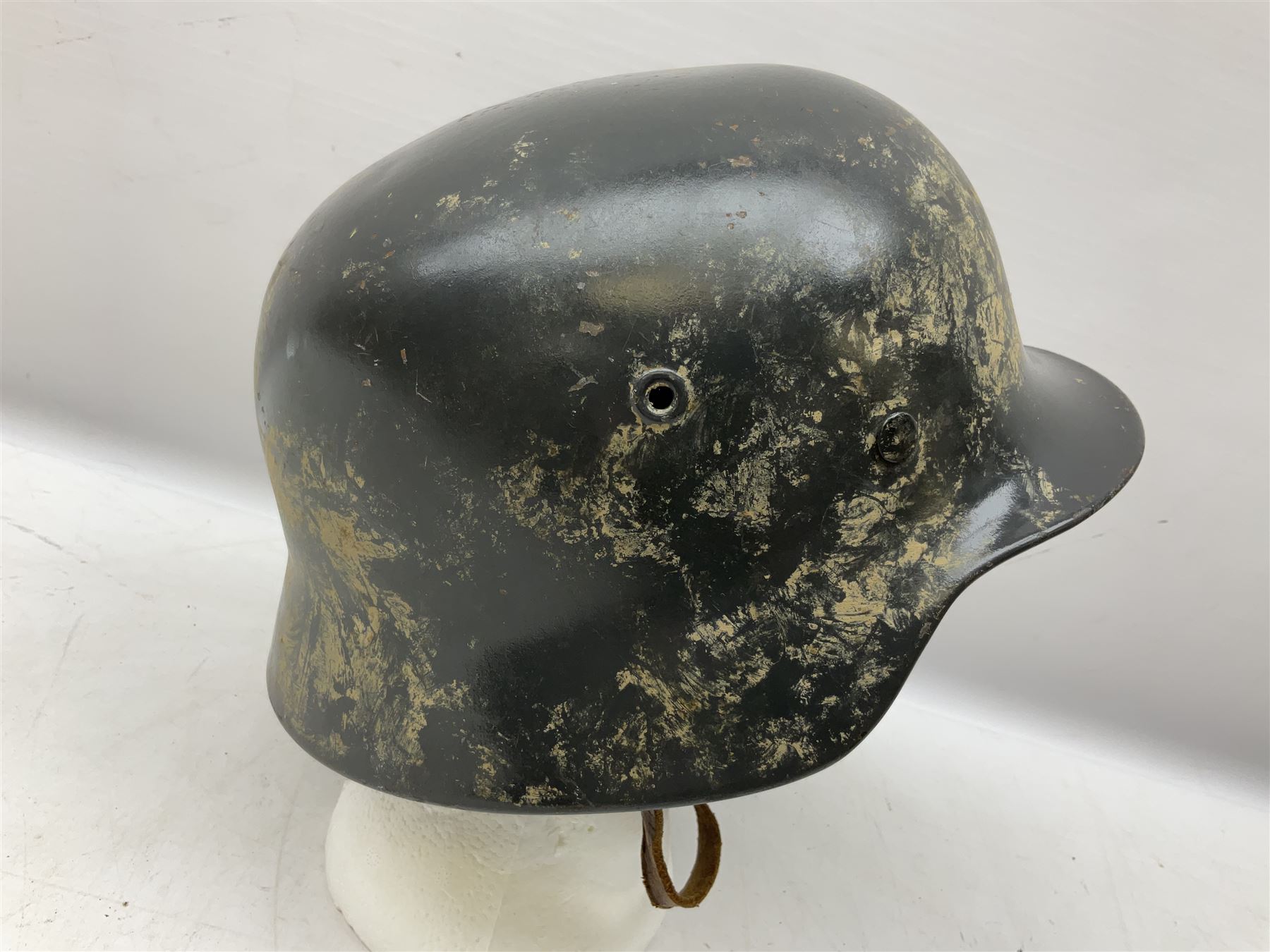 WW2 German steel helmet painted in undecaled Luftwaffe bluey grey with leather liner and chin strap stamped '58', the skirt impressed '1250'