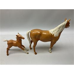 Collection of Beswick horses, including grey horse no.701, palomino foal no 836, grey stocky jogging mare no.855 etc, together two Royal Doulton horses, (8)