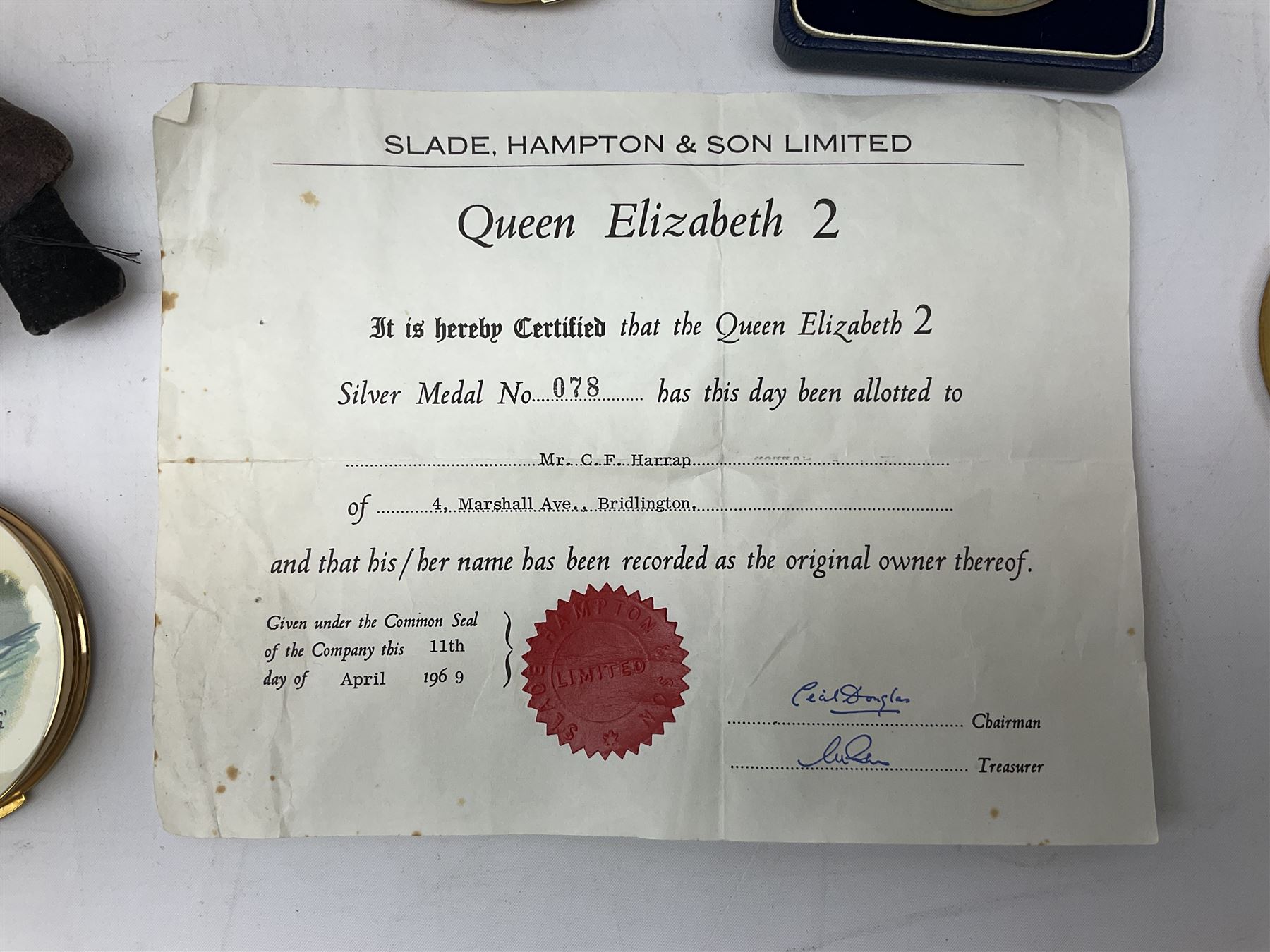 Silver 1969 Cunard RMS Queen Elizabeth maiden voyage commemorative medallion, in original Slade, Hampton & Son case with certificate, two Stratton R.M.S Queen Elizabeth mirror compacts, Stratton R.M.S Queen Mary compact, mid 20th century P&O Canberra Round World Voyage miniature globe, S.S Oriana ash tray modelled as a barrel, Norah Wellings sailor doll, and other maritime and shipping memorabilia 