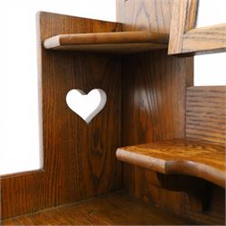 Shapland & Petter - oak mirrored dressing chest, tilted mirror flanked by tulip carved supports, shaped shelves with heart cut outs, above two short over one long drawers, with brass handles and stamped S & P on the locks, raised on shaped supports