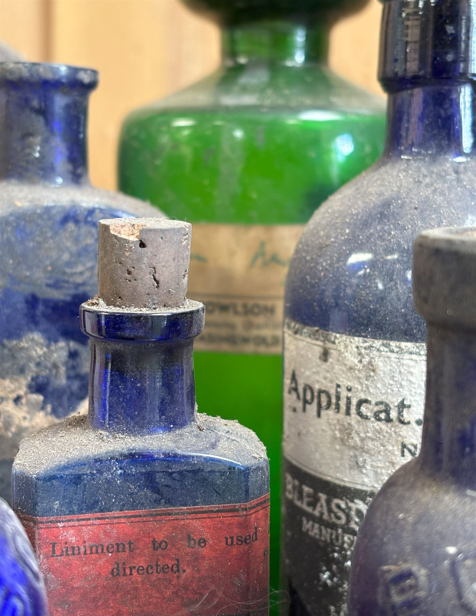Group of thirteen 19th / 20th century blue and green glass poison or apothecary bottles, mostly with paper labels, one from A. Knowlson & Son, Easingwold. (13) - COLLECTION BY APPOINTMENT FROM: The White House, Thirsk Road, Easingwold, York, YO61 3NF - CALL 01723 507111 TO ARRANGE