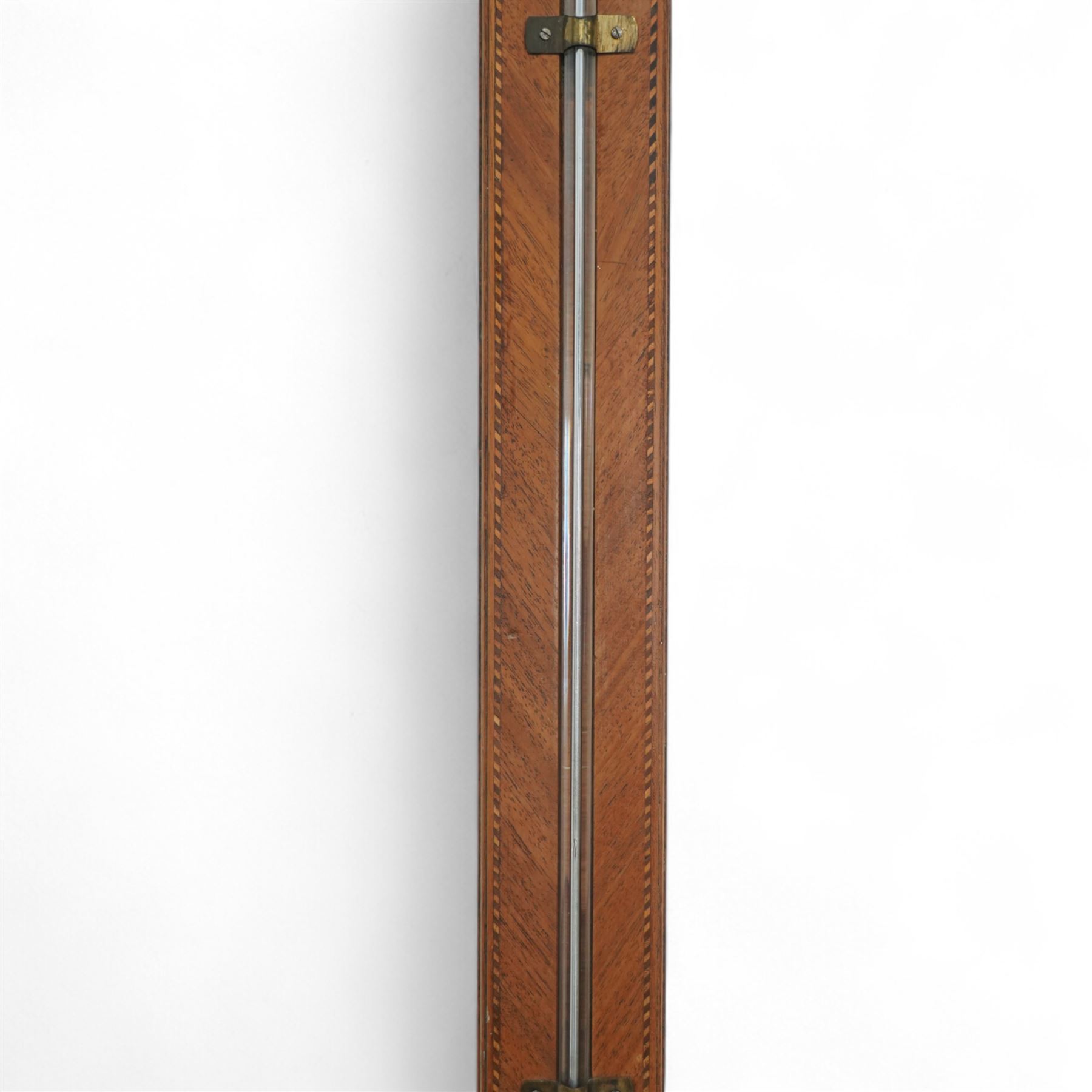 Stampa- George III early 19th-century mercury stick barometer in a mahogany case with a broken pediment and round base, case with chequered inlay to the edge and cistern cover, visible full length bulb cistern tube recording barometric air pressure from 27 to 31 inches with predictions, rectangular silvered register and vernier, with a spirit thermometer indicating the temperature in degrees Fahrenheit.
Mercury present in good condition.
Stampa is recorded as working in London as a barometer and looking glass manufacturer.