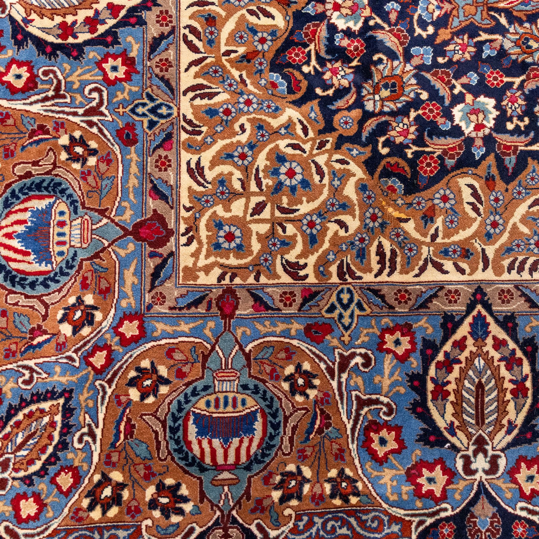 North East Persian Meshed hand-knotted carpet, deep navy field with central complex medallion and densely decorated scrolling floral sprays and palmettes, incorporating cartouche motifs enclosed by a broad tan and dark blue border ornamented by stylized vases flanked by multiple guard stripes, signed 'Amal-e Haji translates as the Work of Haji', with cotton fringe ends 