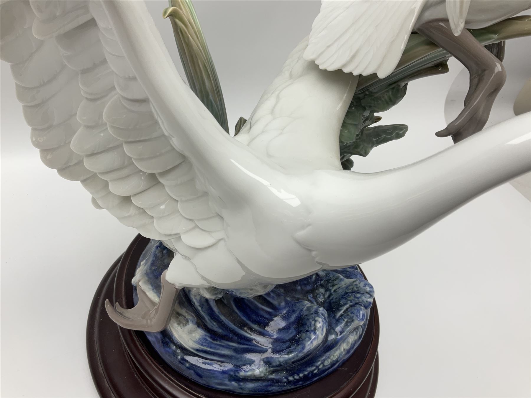 Large Lladro figure group, Swans Take Flight, modelled as two swans upon raised on circular wooden plinth, sculpted by Salvador Debon, H68cm