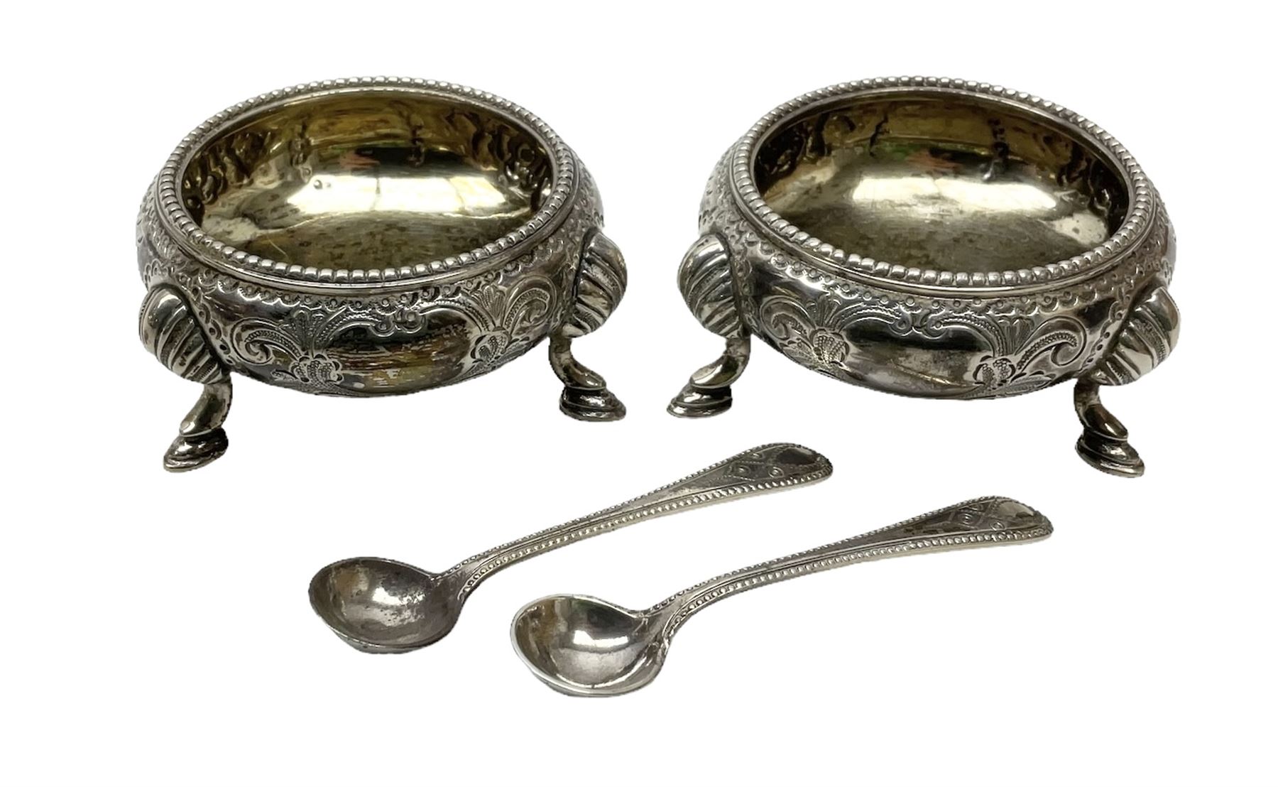 Pair of Victorian silver table salt cellars of cauldron form with gilt interiors, together with accompanying salt spoons, hallmarked Martin, Hall & Co, Sheffield 1879, total weight approx 100.5g