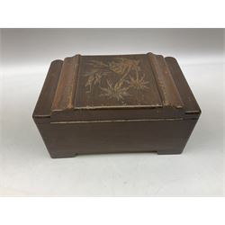 Three Oriental boxes comprising Camphor wood example carved with figures in a scene surrounded by border carved with leaves and flowers, another similar smaller Camphor wood example and further box with carved palm tree design, all with brass fittings (3)