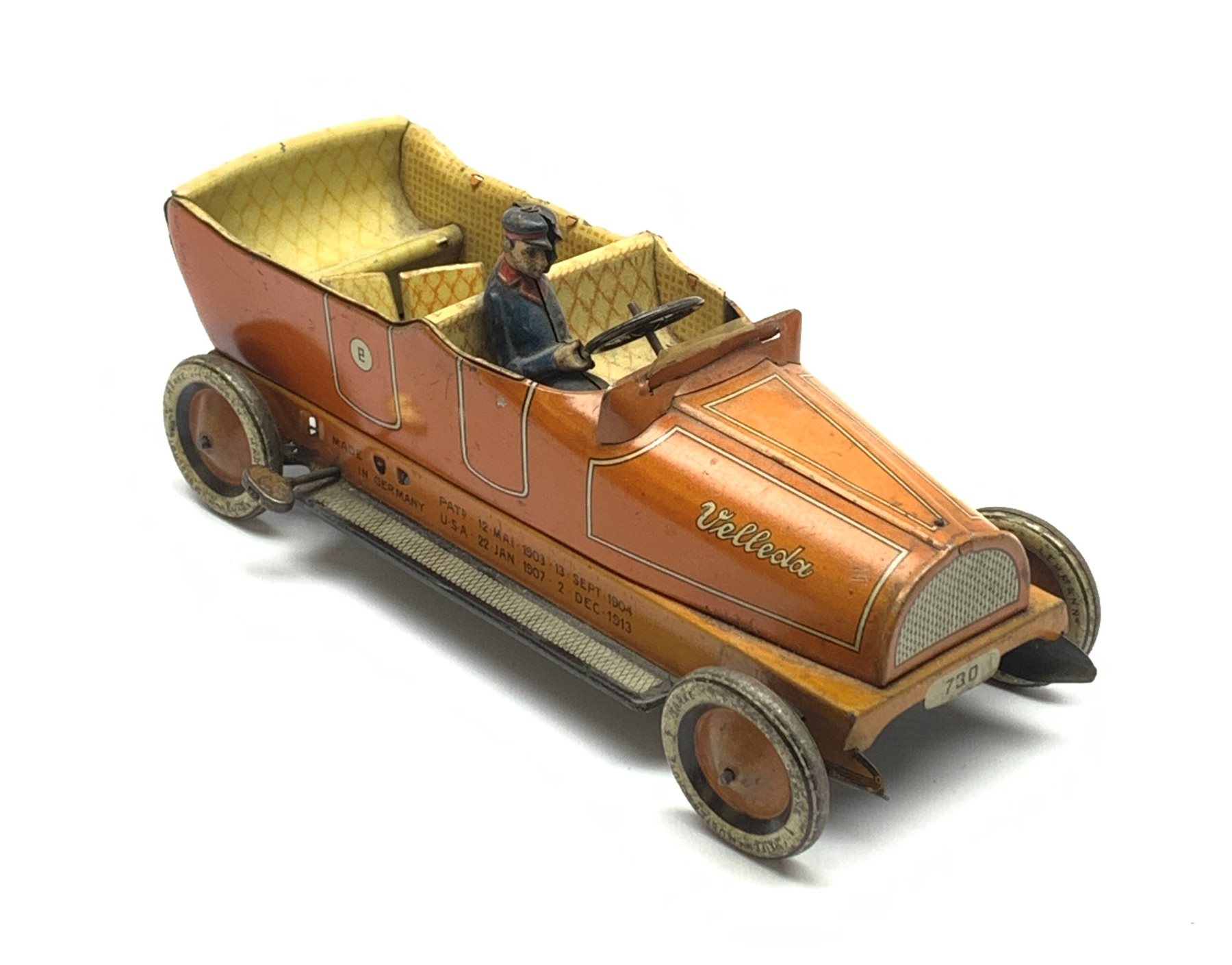 Early 20th century Lehmann clockwork tin-plate open top car with chauffeur, the bonnet inscribed 'Velleda', folding seats and bench seat to the back and integral key, various patent dates up to 1913, L25cm