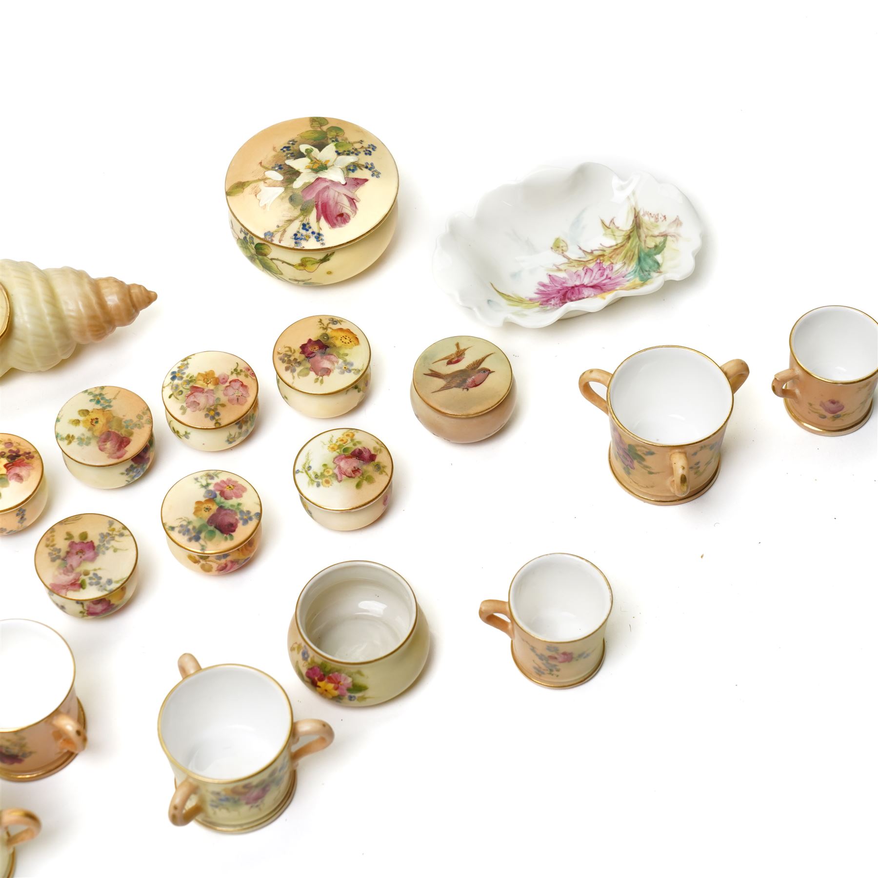 Large collection of miniature Royal Worcester hand-painted blush ivory wares, including shell shaped dish, and various covered trinket dishes, in glazed display case