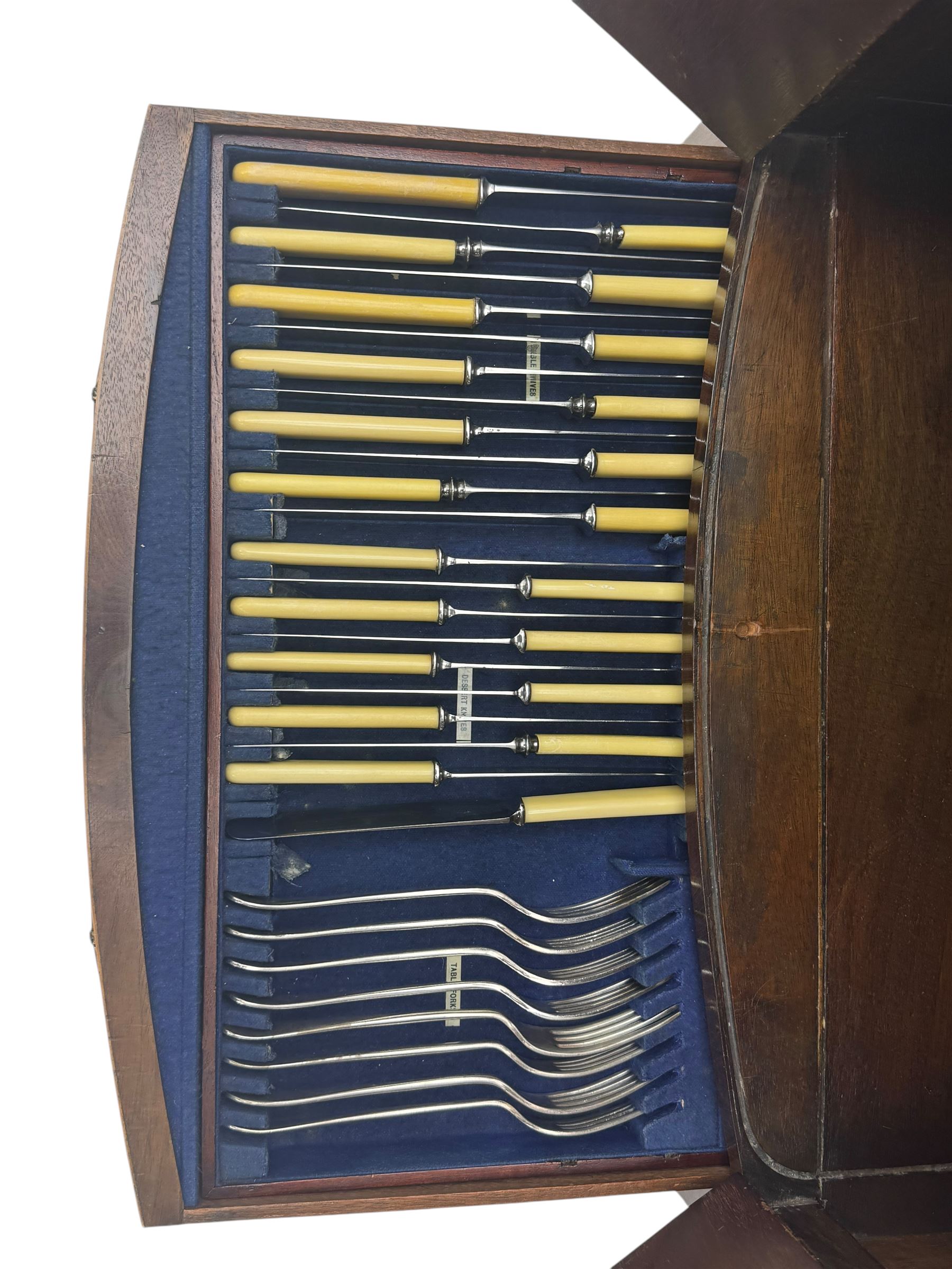 Part canteen of silver plated cutlery, including ivorine handled table and dessert knives, table forks, dessert forks, dessert spoons, teaspoons and soup spoons, all contained within a canteen cabinet converted from a George III mahogany enclosed wash stand