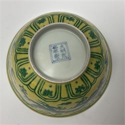 Pair of Chinese famille jaune bowls, decorated in green enamel with a dragon chasing a flaming pearl amongst clouds, upon a yellow ground, the interior decorated to centre with dragon, with six character mark beneath, D17.5cm
