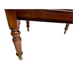 19th century mahogany extending dining table, moulded rectangular top with rounded corners, additional leaf, on turned and fluted supports with brass and ceramic castors