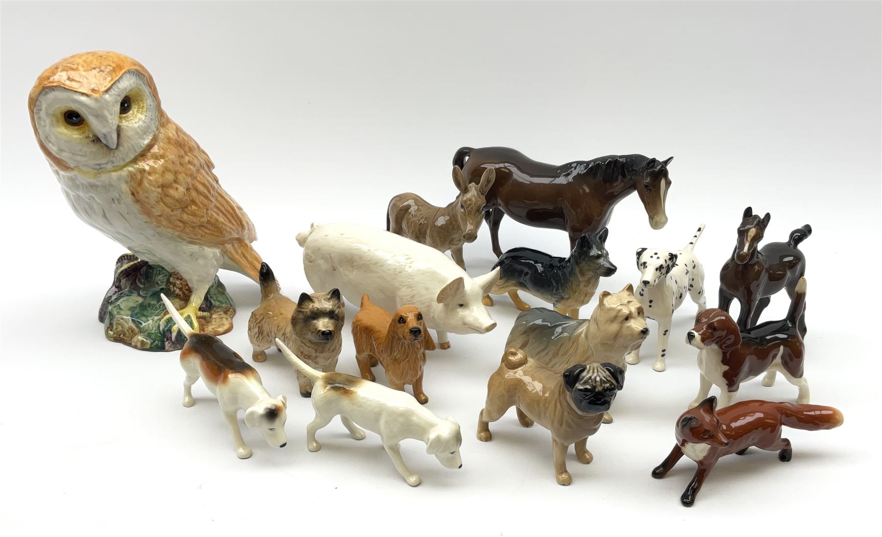 A group of Beswick figures, comprising Barn Owl 1046, various small dog figures including Yorkshire Terrier, Cairn Terrier, Dalmatian, Beagles, Pug, etc., CH Wall Champion Boy 53 pig, fox, donkey, horse, and foal. 