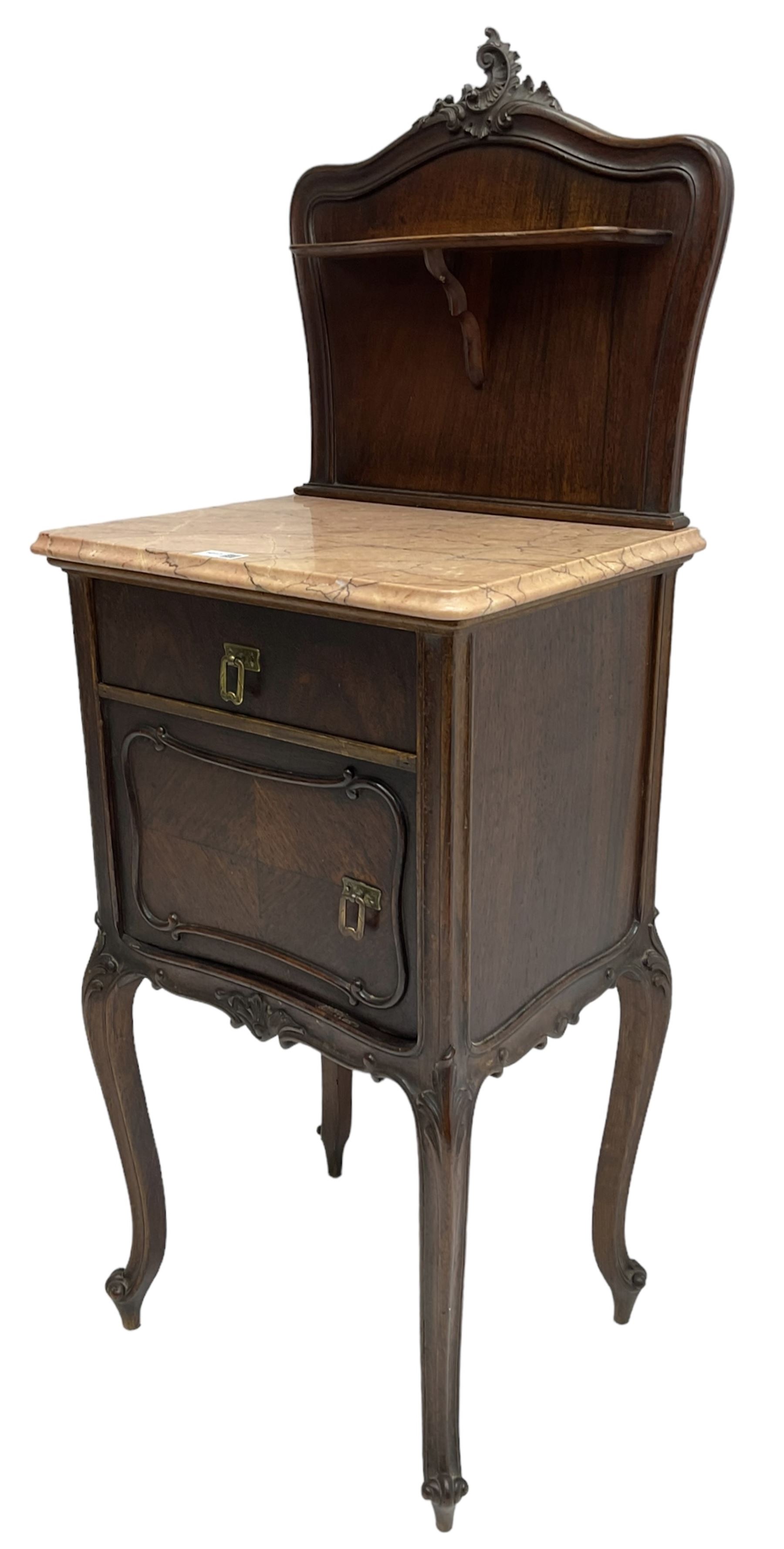 Late 19th to early 20th century walnut bedside pot cupboard, the shaped raised back with carved C-scroll pediment, pink variegated marble top, fitted with single drawer and cupboard, foliage carved cabriole supports with scroll carved terminals