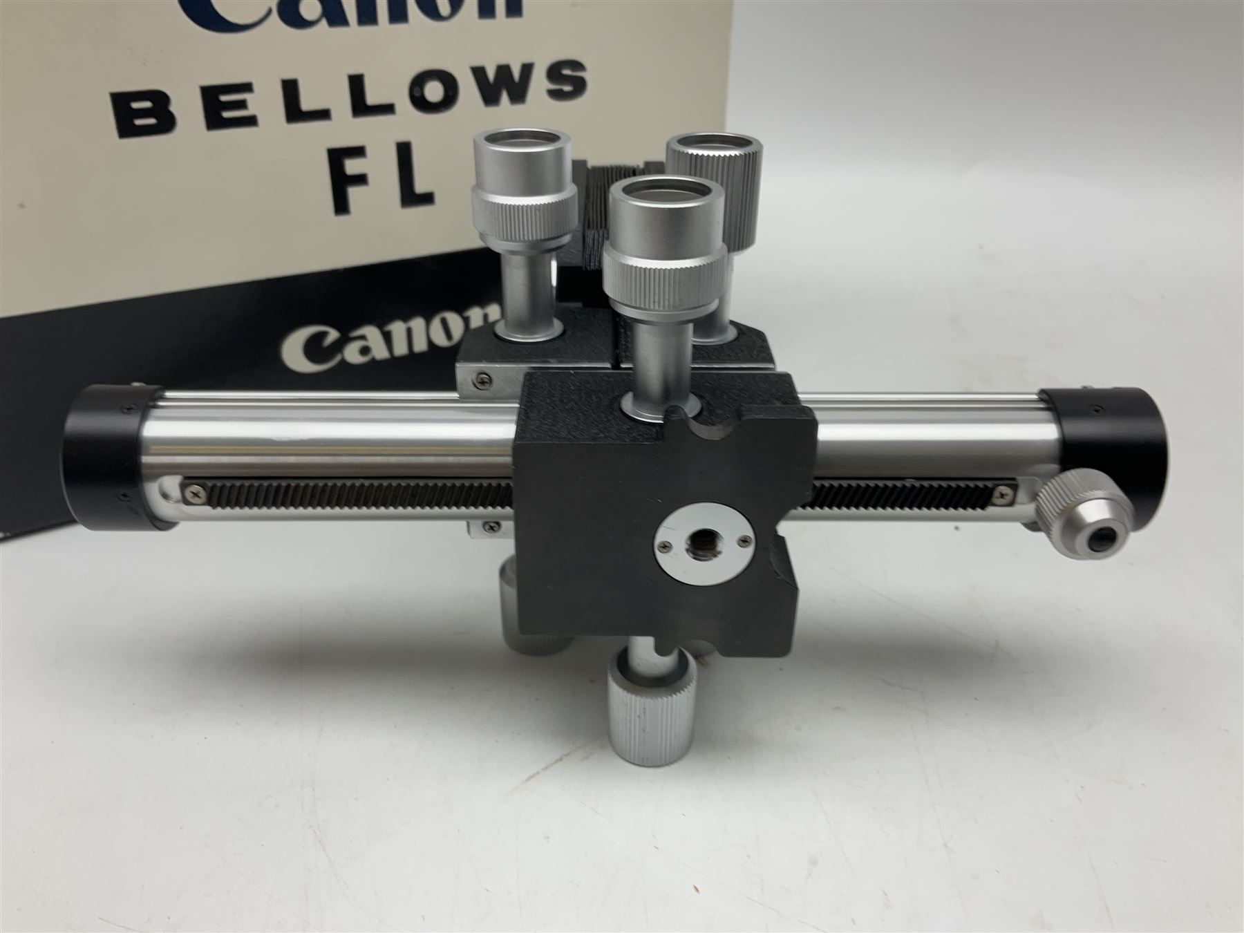 Collection of Canon lenses, to include 'Canon Lens FD 100mm 1:2.8', serial no 12821, 'Canon Lens FD 200mm 1:4' serial no 245313, 'Macro Canon Lens FL 50mm 1:3.5', serial no. 25505, 'Canon Lens FD 135mm 1:3.5 etc, together with other Canon equipment, including Bellows FL, Slide Duplicator etc 