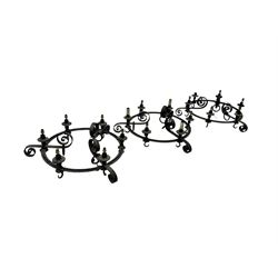Set of three mid-20th century wrought iron six-light chandeliers, each with a circular frame with scrolled arms, faux candle sleeves and hook terminals