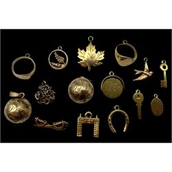 9ct gold charms, including crossed swords, signet ring, horseshoe and leaf, and a 14ct gol...