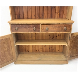  Victorian pitch pine dresser, two glazed doors enclosing fitted shelves, above two drawers and two cupboards, plinth base, W123cm, H216cm, D40cm  