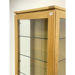 Solid light oak glazed display cabinet, fitted with two base drawers