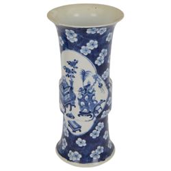 Late 19th century Chinese blue and white gu beaker vase, decorated with two lobed reserves containing precious objects, against a prunus and cracked ice ground, with apocryphal Kangxi mark beneath, H30.5cm