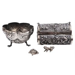 Continental silver bowl, of circular lobed form, repousse decorated with tribal and hunting scenes, upon three claw feet, unmarked but testing as 800 silver, H5cm, together with Chinese silver purse, of domed rectangular form, with ornate repousse decoration, depicting flowers, instruments, birds etc, with lobed wire wrapped handle, with Chinese character marks beneath, testing 650 silver,  including handle H11cm, and two base metal miniature animals