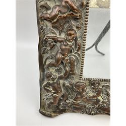 20th century copper frame, decorated in relief with cherubs and putties in foliate surround, H29cm
