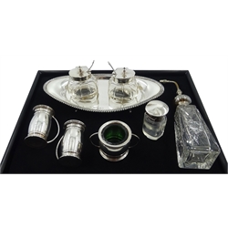  Silver boat shaped cruet stand by Henry Matthews Birmingham 1908 with two cut glass silver topped mustards and spoons 20cm and an Arts and Crafts three piece cruet by Levi & Salaman Birmingham 1911 weighable silver 6.9oz, a cut glass atomiser and scent bottle both with silver tops  