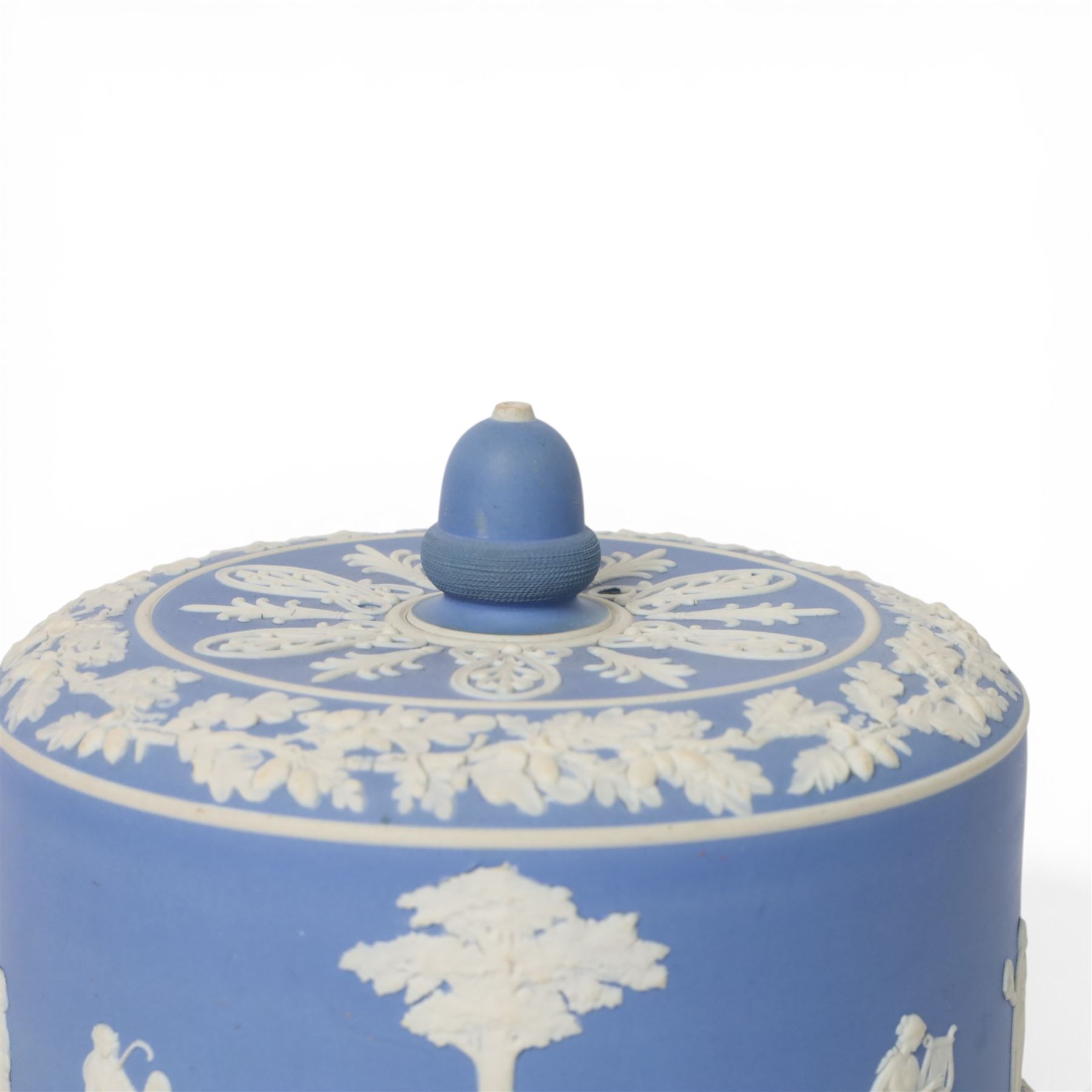 19th century Jasperware cheese dome decorated with classical figures in relief, with borders of oak leaves, with acorn finial, H22cm
