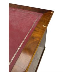 Late 19th to early 20th century walnut pedestal desk, rectangular top inset with red tooled leather writing surface, over a central frieze drawer flanked by two pedestals, each fitted with four graduated drawers with brass escutcheons and drop handles, the whole raised on a plinth base