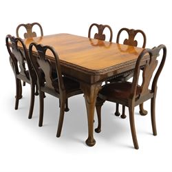 Queen Anne design walnut dining suite, comprising a rectangular dining table with carved moulded edge and rounded corners, raised on cabriole legs terminating in pad feet, together with a set of six matching dining chairs, each with shaped splat back, leather upholstered seat and cabriole supports (Extends to 230cm)