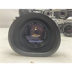 Four Olympus camera bodies, including Olympus OM10, serial no 20744269, with 'Olympus OM-System Zuiko Auto-S 50mm 1:1.8' lens serial no 3633644, Olympus OM-2 camera body serial no 460280 with 'Olympus OM-System G.Zuiko Auto-s 1:1.4 f=50mm' lens, serial no 729750, etc 