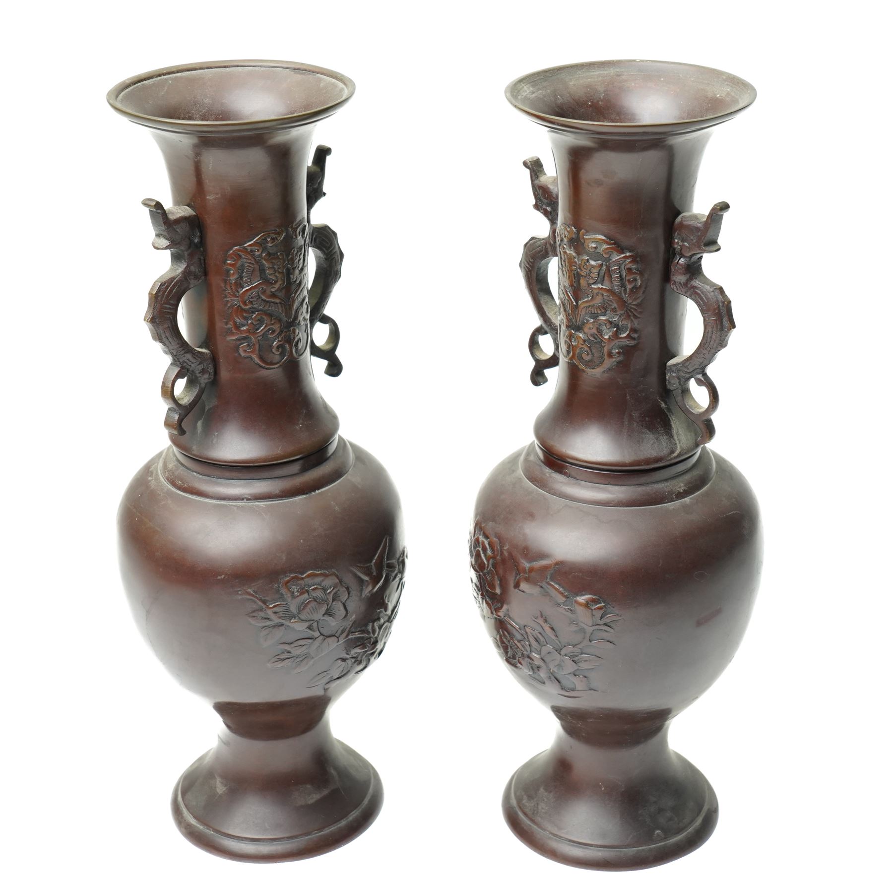 Pair of Japanese bronze vases, with twin handles in the form of dragons, decorated with flowers and traditional motifs to the neck and body, H31cm (2)