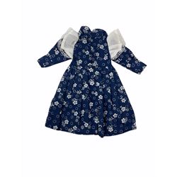 Heidi Ott doll in tartan dress, navy floral dress with white lace and ribbon detailing, striped blue and white dress and a 'Head to Toe' book