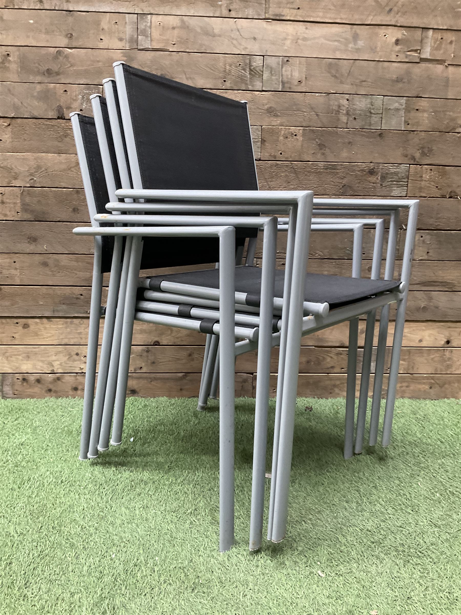 Rectangular metal framed garden table with glass top and four stackable chairs - THIS LOT IS TO BE COLLECTED BY APPOINTMENT FROM DUGGLEBY STORAGE, GREAT HILL, EASTFIELD, SCARBOROUGH, YO11 3TX