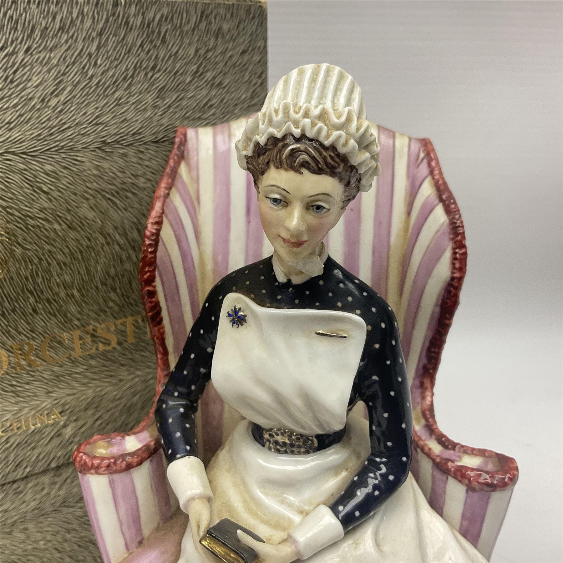 Royal Worcester limited edition figure, Sister St Thomas Hospital (London), no 180/500, modelled as a nurse in uniform, sitting on a striped wingback chair, with printed mark beneath, in original box with certificate, H16cm