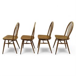 Ercol - Windsor dining chairs, set of four, each with rounded hoop back and four stick spindles, shaped elm seats with exposed plugs, raised on splayed beech tapering legs