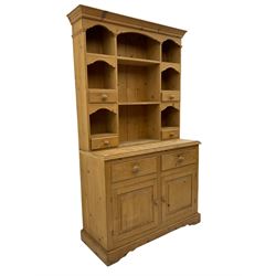 Solid pine dresser, raised plate rack fitted with small drawers over two drawers and double cupboard, plinth base