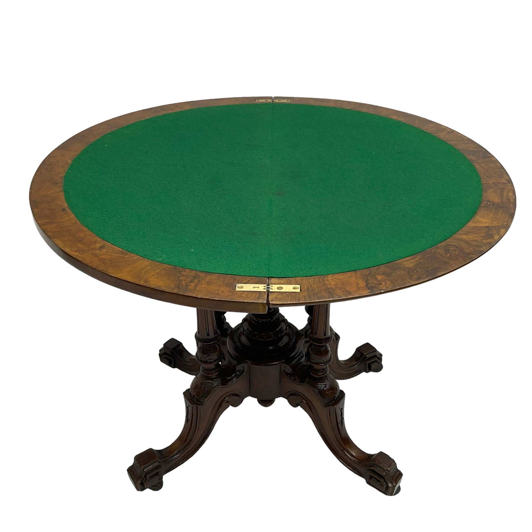Victorian figured walnut demi-dune card table, the fold-over moulded top with circular baize lining, on four turned pillars with central finial platform, four splayed moulded supports with angular scrolled feet, on castors