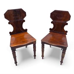 Pair of 19th century mahogany hall chairs, each with shaped octagonal backrest featuring a...