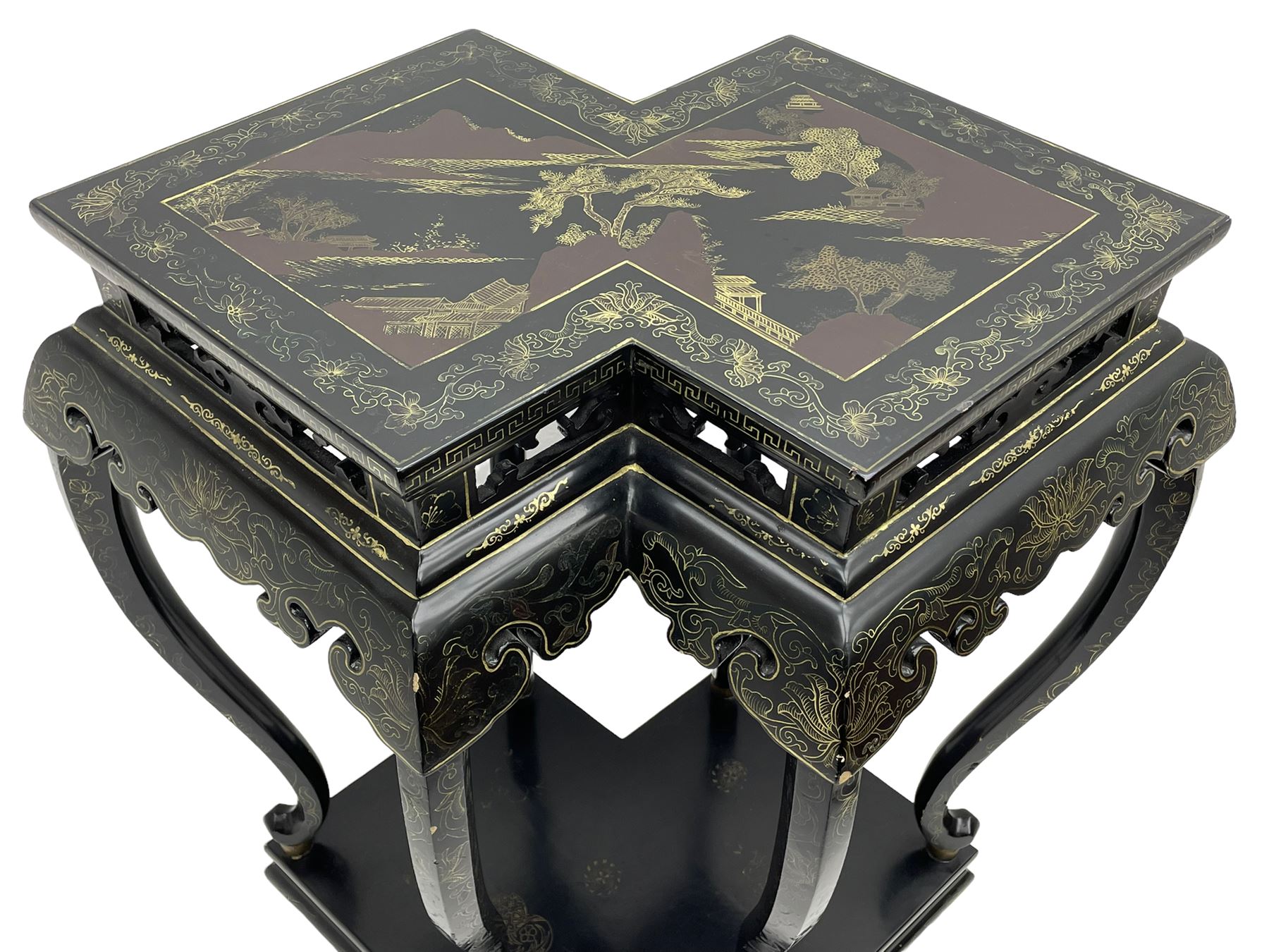 Chinese black lacquer double jardinière stand, the double-lozenge top painted with traditional landscape scenes within a gilt strung border, the pierced frieze with trailing foliate decoration and geometric patterns over the shaped projecting apron, supported on six cabriole supports united by a hexagonal undertier, raised on compressed spade feet