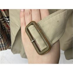 Ladies Burberry double breasted trench coat, with belt and detachable woollen gilet, in traditional cream colour with Burberry check lining, together with a gentlemans Burberry single breasted trench coat, both L112cm