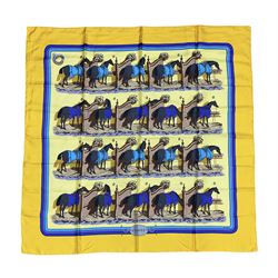 Hermès 'Ecuries' silk scarf, designed by Hugo Grygkar in 1947, printed with twenty horses in their respective stables, on yellow ground contained within stitched effect blue and purple and darker yellow gold borders, with rolled hand stitched edges and Hermes material label, 87cm square