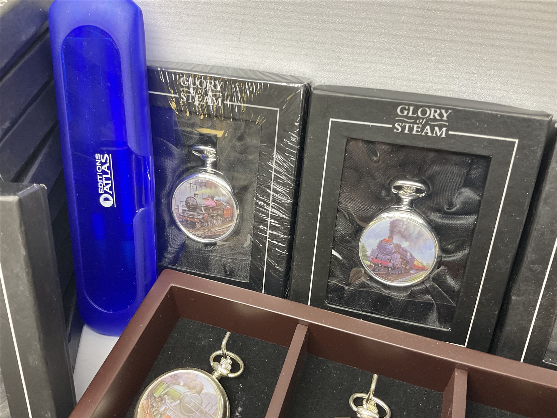 Twenty-three Glory of Steam Atlas Editions silver plated pocket watches, to include The Scottish Horse, Merchant Navy Class, etc, with wood display case, all boxed, twenty one with certificates