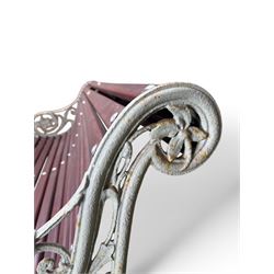 Large late Victorian cast iron garden bench, serpentine form with scroll back and seat, slatted with mahogany stained Sapele