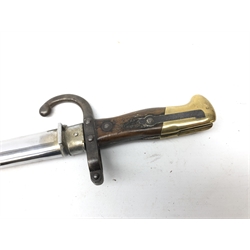  French Gras Bayonet, 52.5cm tapering steel triangular blade engraved St.Etienne 1899, guard stamped 80185 with curved quillon, wooden grip with brass pommel, in chromed scabbard, L66cm   